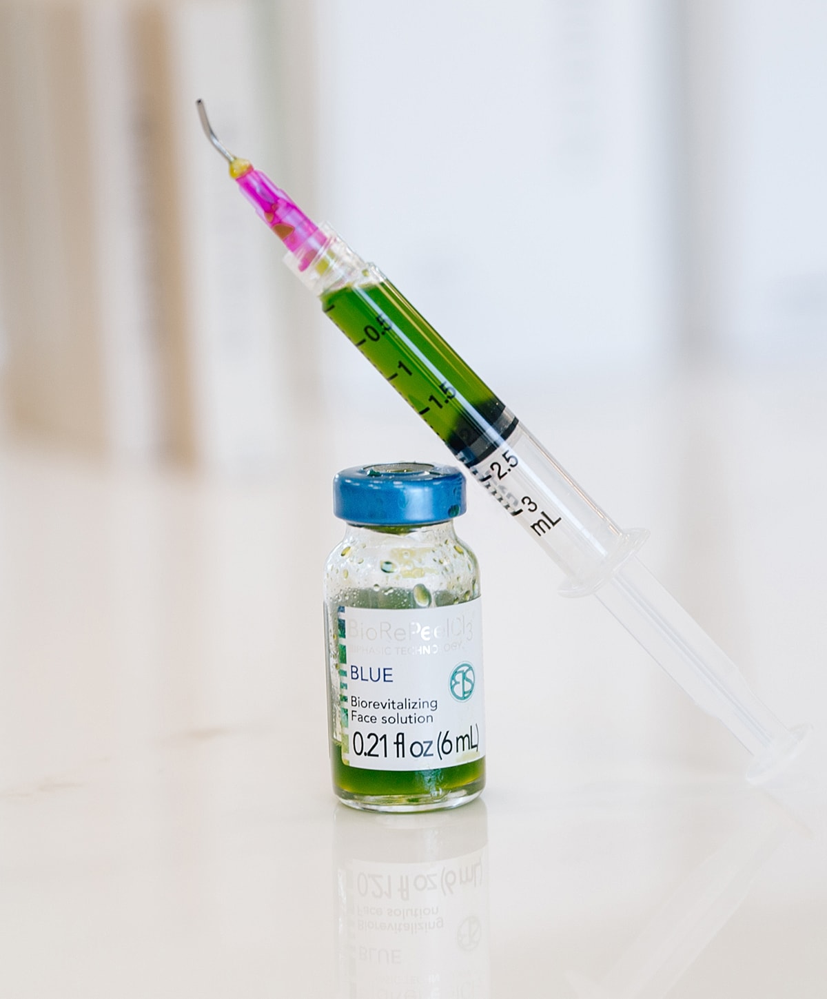 Syringe and vial of biorevitalizing solution.