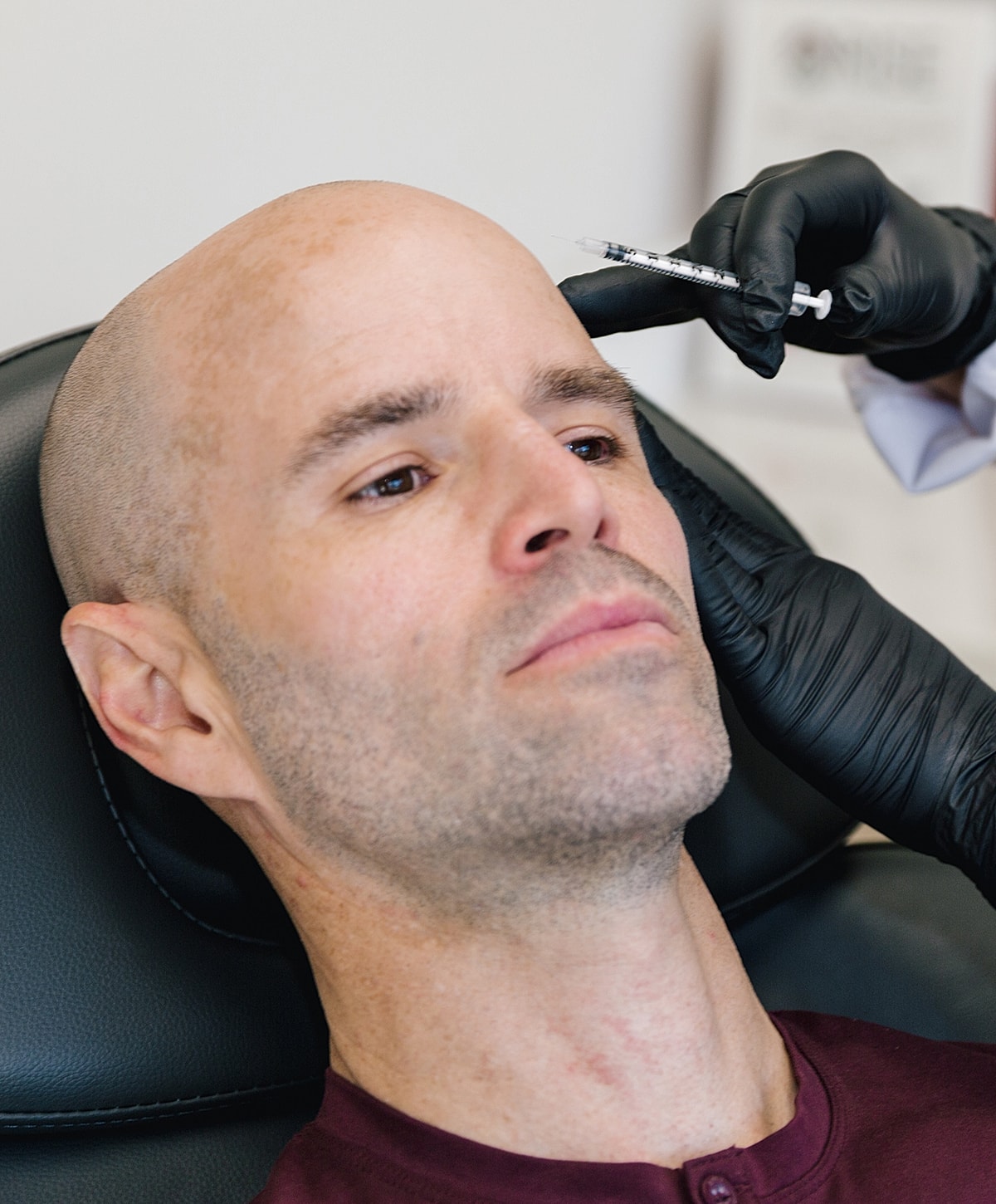 Salt Lake City botox model receiving an injection in a clinic setting.