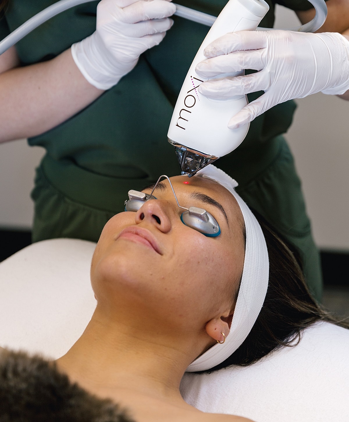 Facial treatment using a laser device on skin.