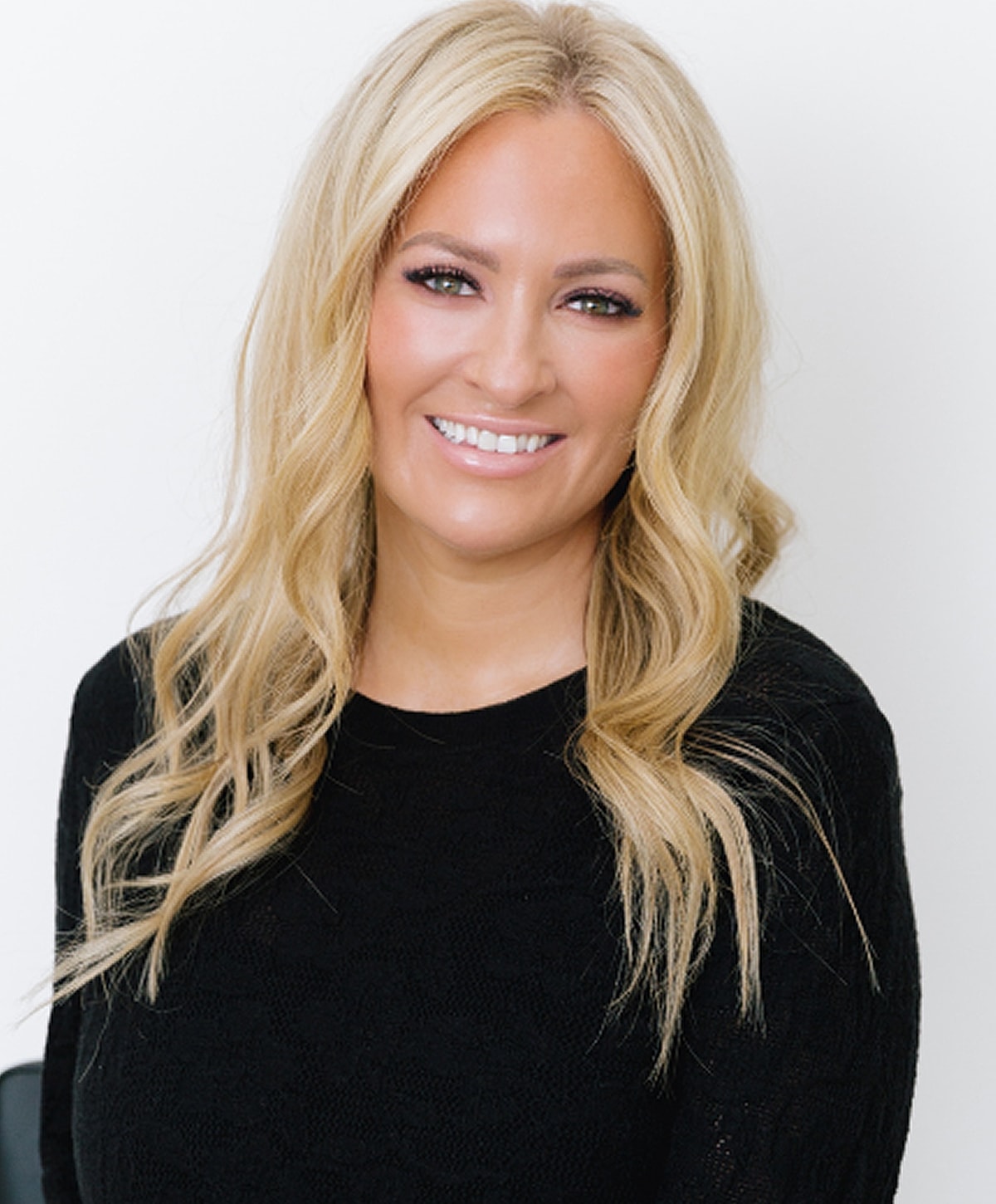 Smiling woman with long blonde hair.