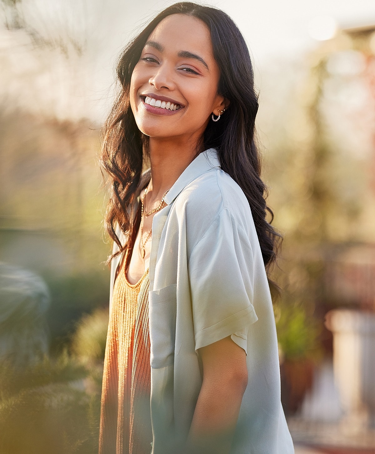 Smiling Salt Lake City chemical peel model in a sunlit outdoor setting