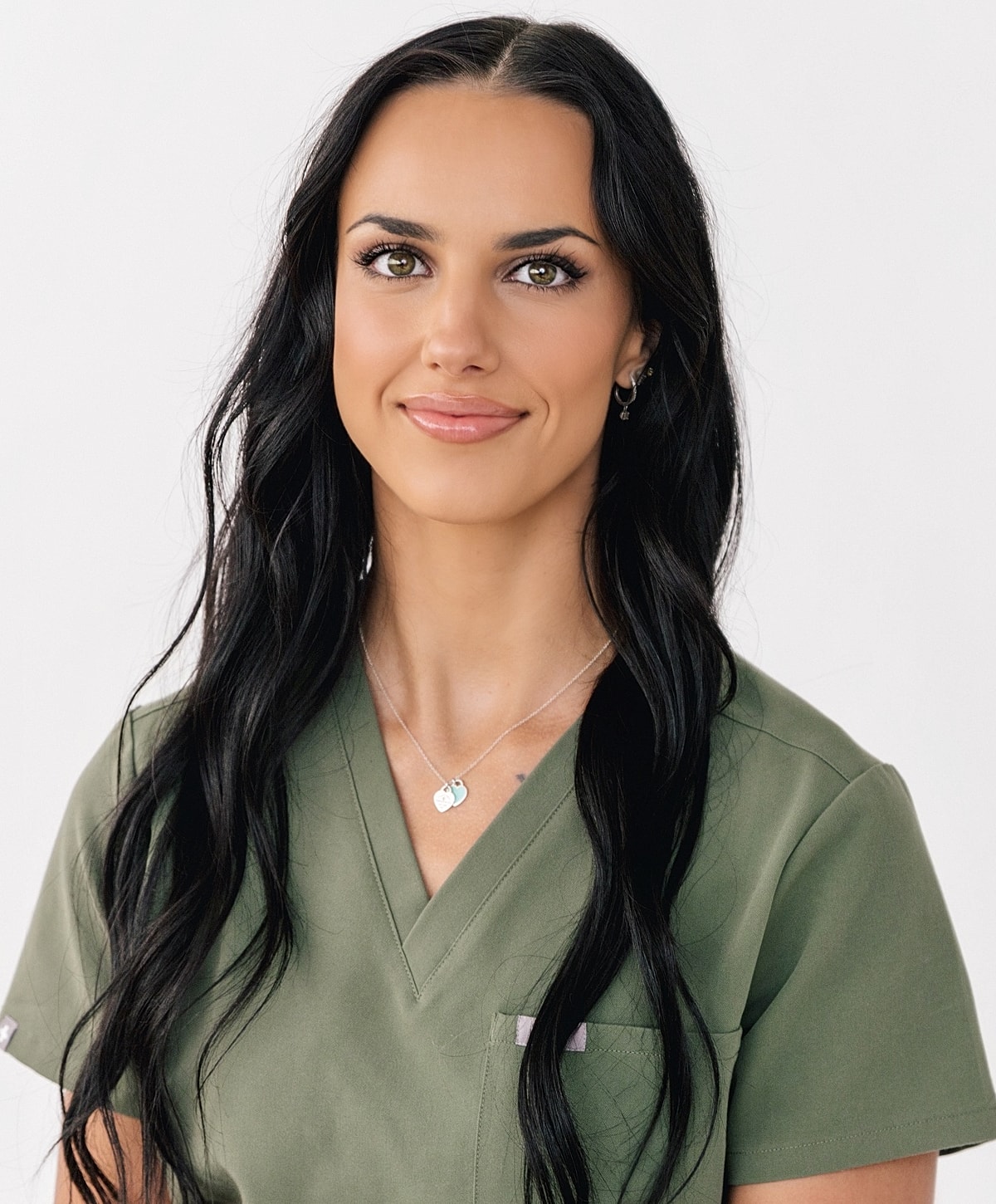 Female healthcare professional with long black hair.