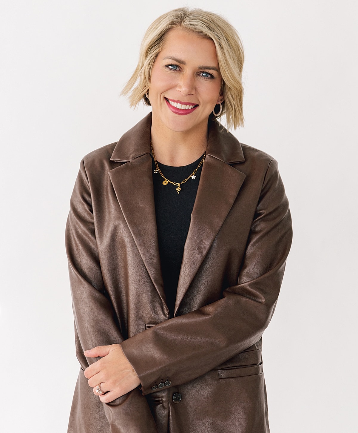 Smiling person in brown leather jacket.