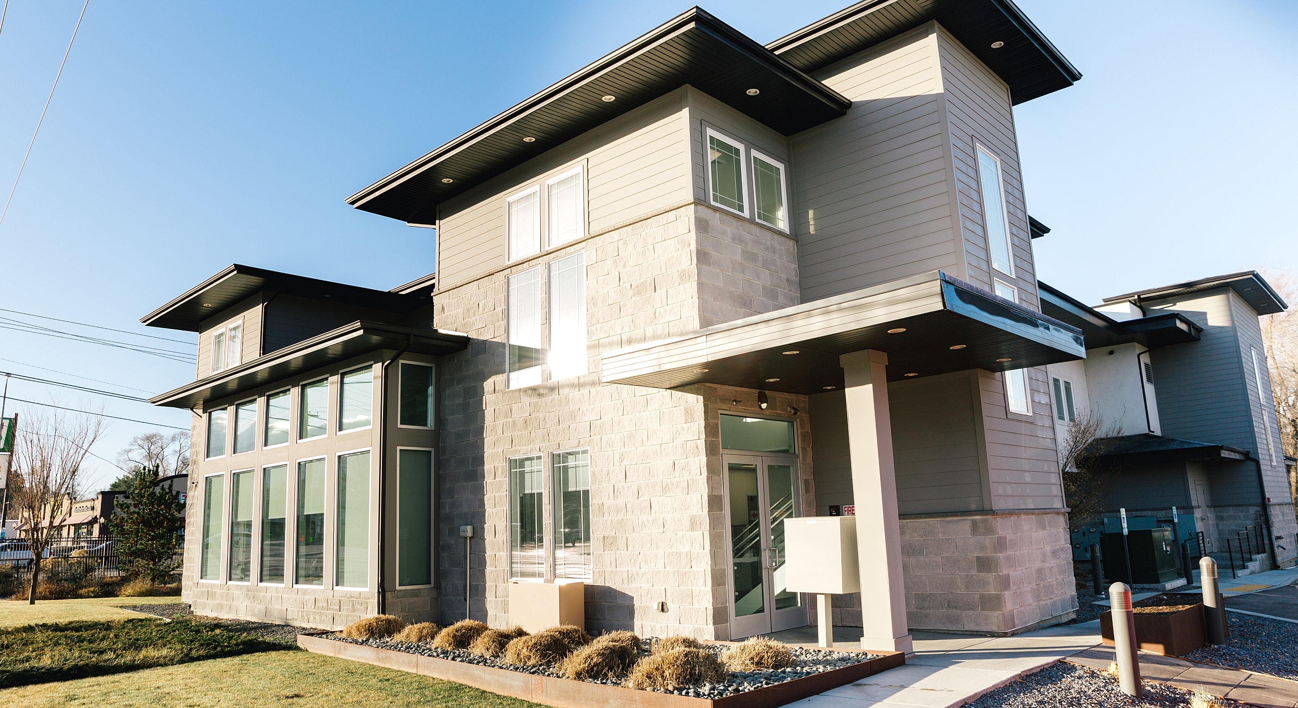 Modern two-story building with large windows.
