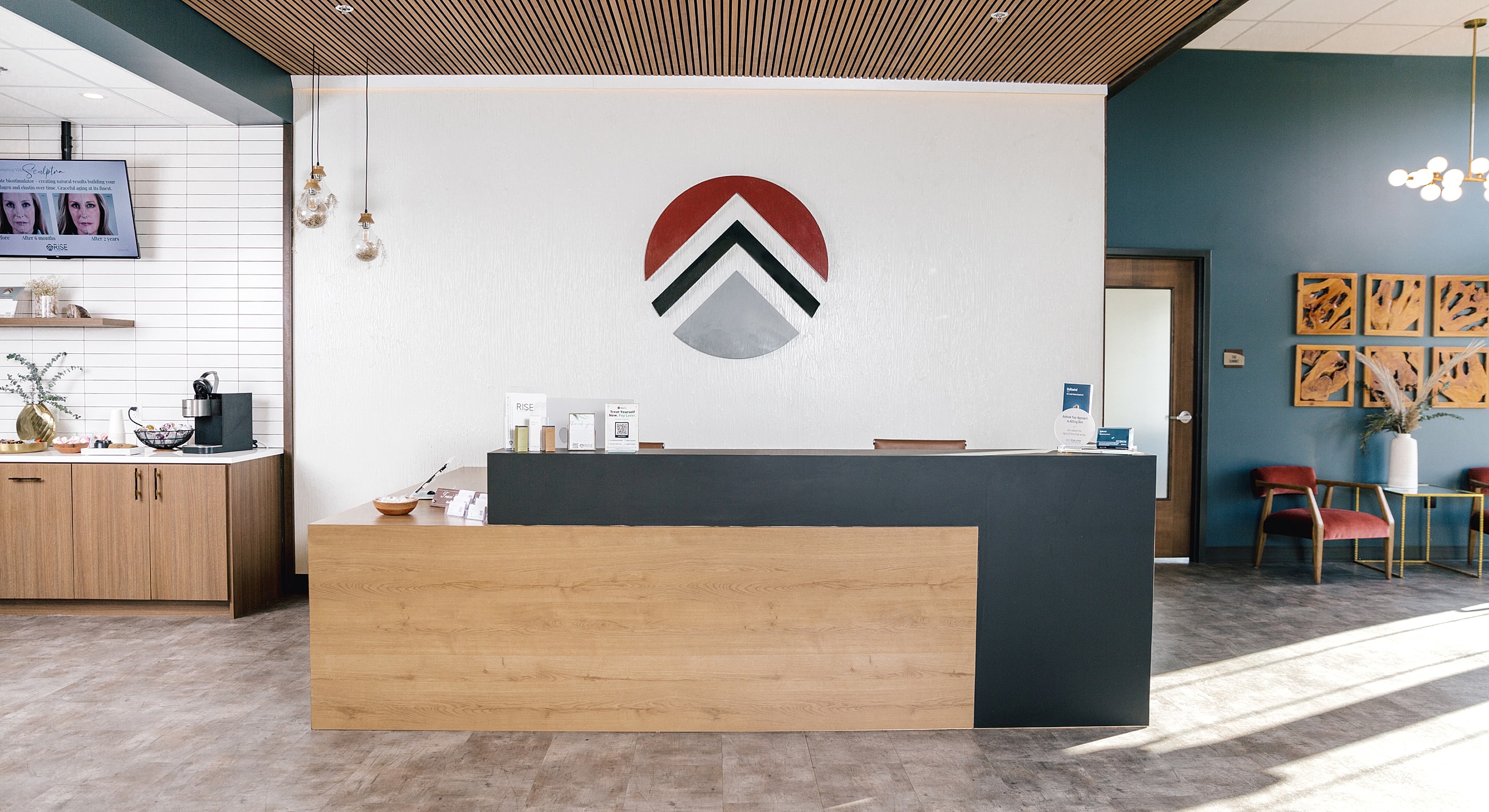 Modern reception area with logo and decor.