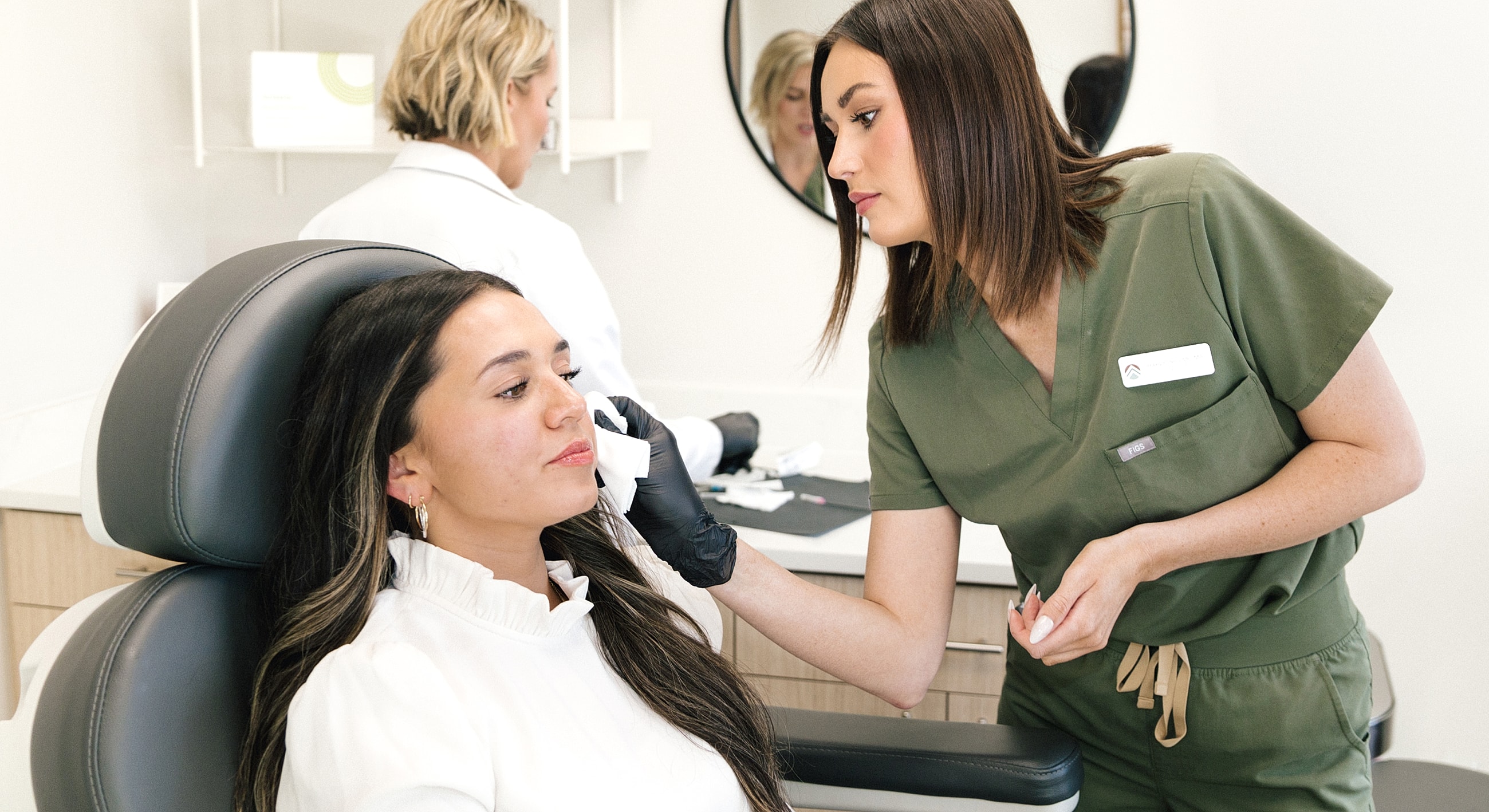Woman receiving a skincare treatment in clinic.