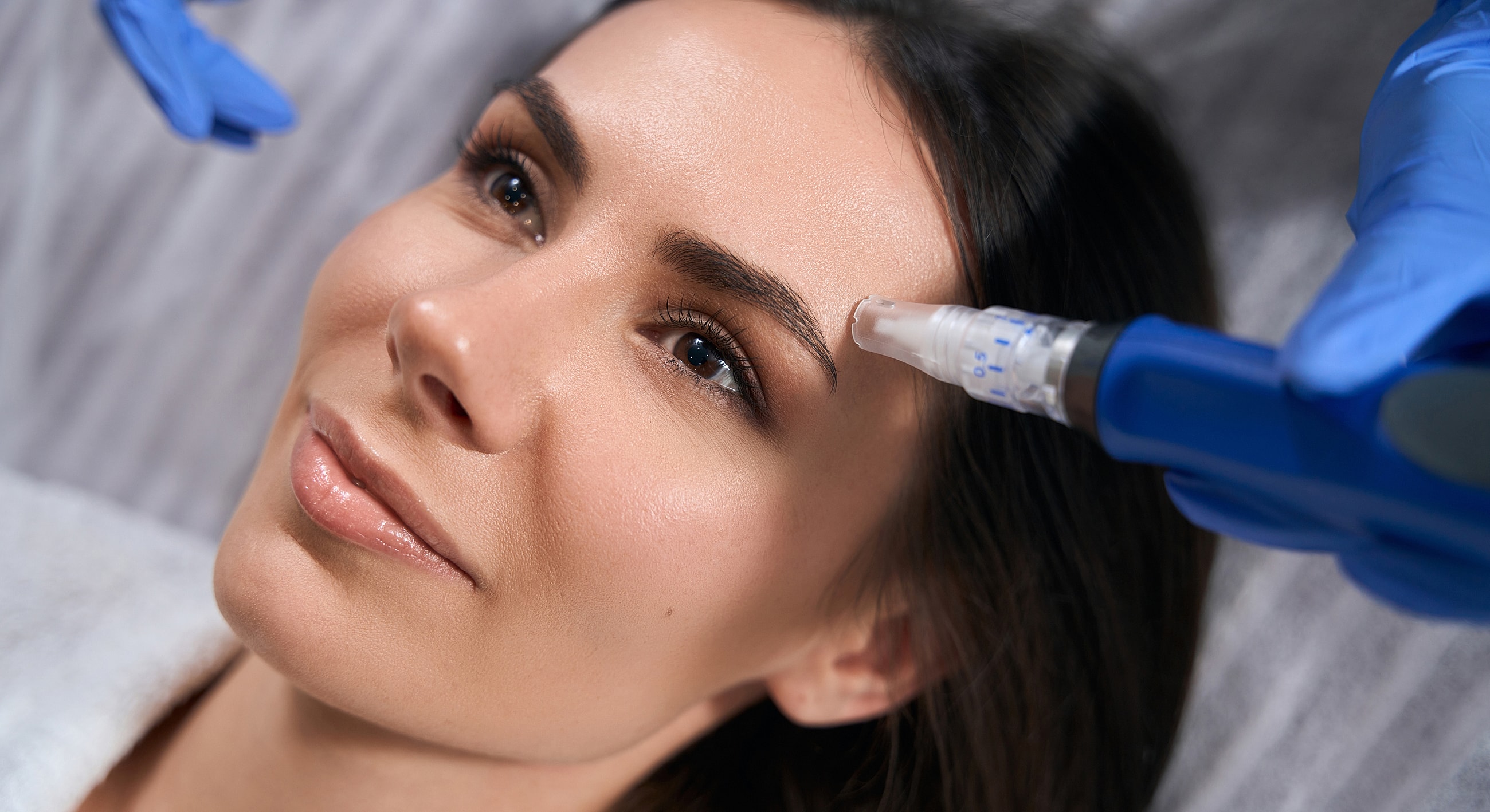 Woman receiving facial treatment in a clinic.