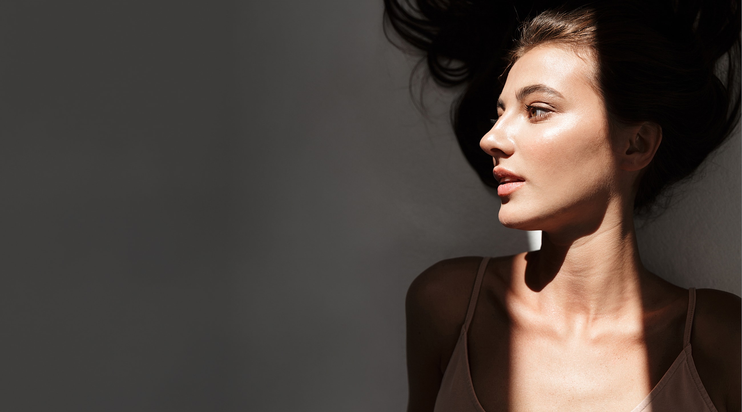 Profile of a woman with flowing hair.